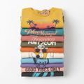 A neatly folded stack of colorful assorted graphic tees