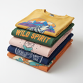 A neatly folded stack of 5 colorful assorted graphic tees